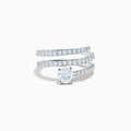 The Lab Grown Diamond Wrap Around Round Ring in 14K white gold showcases three curved, diamond-studded bands and a large round lab diamond at the center, set against a white background.