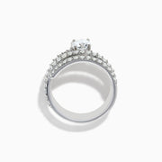 The Lab Grown Diamond Wrap Around Round Ring in 14K white gold showcases three curved, diamond-studded bands and a large round lab diamond at the center, set against a white background.