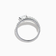 The Lab Grown Diamond Wrap around Pear Ring in 14K White Gold showcases a pear-shaped central diamond and a split shank adorned with lab diamonds, elegantly displayed on a plain white background.