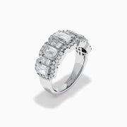 The Lab Grown Emerald Cut Diamond Halo Band in 14K White Gold showcases a luxurious row of large emerald-cut lab grown diamonds, accented by smaller round diamonds in an intricate halo design.
