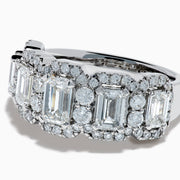 The Lab Grown Emerald Cut Diamond Halo Band in 14K White Gold showcases a luxurious row of large emerald-cut lab grown diamonds, accented by smaller round diamonds in an intricate halo design.