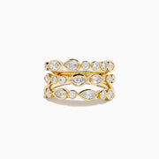 The Lab Grown Multi Shape Diamond Triple Row Bezel Ring in 14K Yellow Gold features three stacked bands with round and marquise lab grown diamonds set in bezel settings, creating a repeating diamond pattern around each row.