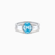 The Lab Grown Blue and White Diamond 3-Stone Ring in 14K White Gold showcases an oval blue diamond flanked by tapered white baguette diamonds, all set against a plain white background.