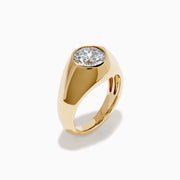 The Lab Grown Diamond Bezel Signet Pinky Ring in 14K Yellow Gold features a wide band and a large, round lab grown diamond at the center, shown against a plain white background.