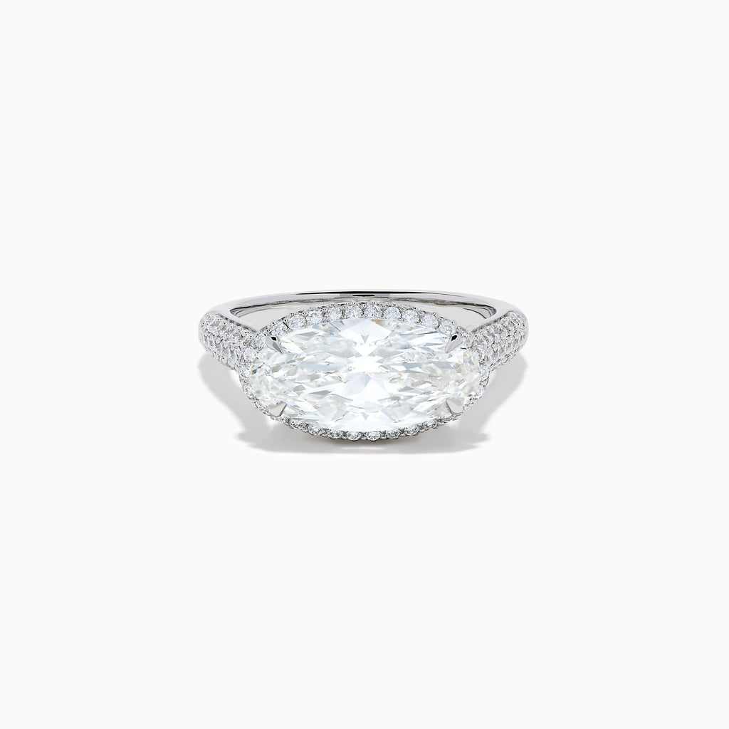 The Lab Grown Diamond East-West Oval Halo Ring in 14K White Gold showcases a brilliant lab-grown diamond center, accented by sparkling stones along the band, beautifully set against a plain white background.
