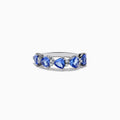 The Nahla Siri 14K White Gold Tanzanite and Diamond Ring features five heart-shaped blue tanzanite gemstones set side by side on a slender band, displayed on a white background.