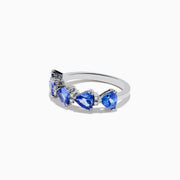 The Nahla Siri 14K White Gold Tanzanite and Diamond Ring features five heart-shaped blue tanzanites in a row, each accented by sparkling diamonds, presented on a white background.
