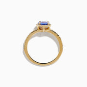 The Nahla 14K Yellow Gold Tanzanite and Diamond Ring showcases a round tanzanite center, encircled by a halo of clear diamonds and accented with additional diamonds along the band.