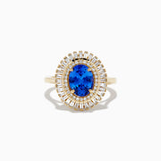 The Nahla Siri 14K Yellow Gold Tanzanite and Diamond Ring features an oval-cut tanzanite center with two halos of baguette and round diamonds, beautifully presented on a plain white background.