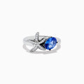 The Nahla Siri 925 Silver Tanzanite and Diamond Starfish Ring features a diamond-studded starfish next to an oval tanzanite gemstone, all displayed on a plain white background.