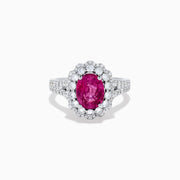 The 18K White Gold Pink Sapphire and Diamond Halo Ring features an oval pink sapphire surrounded by a diamond halo, with additional diamonds along the band for extra sparkle.