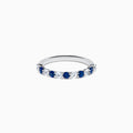 The Royale Bleu 14K White Gold Blue and White Sapphire Band Ring features alternating round blue and white sapphires on a sleek white gold band, shown against a white background.
