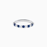 The Royale Bleu 14K White Gold Blue and White Sapphire Band Ring features alternating round blue and white sapphires on a sleek white gold band, shown against a white background.