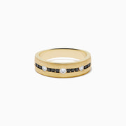 The Mens 14K Yellow Gold White and Black Diamond Band Ring features alternating black and white round diamonds set in the center, showcased against a plain white background.