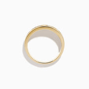The Mens 14K Yellow Gold White and Black Diamond Band Ring features alternating black and white round diamonds set in the center, showcased against a plain white background.