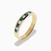 The Bella Bleu 14K Yellow Gold White and Blue Diamond Ring features alternating round blue and white diamonds in a single row, displayed on a plain white background.