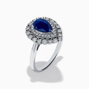 The Royale Bleu 14K White Gold Sapphire Diamond Ring showcases a pear-shaped sapphire center, encircled by two rows of sparkling round white diamonds in an elegant teardrop halo design.