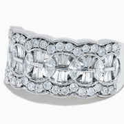Experience timeless elegance with the 14K White Gold Diamond Multi Shape Wide Band Ring, showcasing two rows of brilliant round diamonds that border a central row of rectangular baguette-cut diamonds arranged in an intricate, repeating pattern.