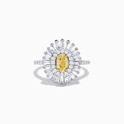 The Canare 18K Two Tone Gold Yellow and White Diamond Ring features an oval yellow centerpiece with a starburst halo of round and baguette white diamonds on a slim, diamond-studded band.