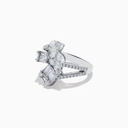 The Classique 14K White Gold Diamond Crossover Ring features an elegant, twisting band set with round and baguette-cut diamonds, shown against a white background.