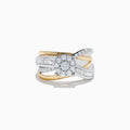 The Duo 14K Two Tone Gold Diamond Cross Over Ring 0.89 TCW features a round diamond cluster at the center and baguette-cut diamonds along the split shank, beautifully crafted for a stunning look.