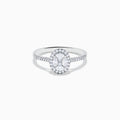 The Classique 14K White Gold Diamond Cluster Ring features an oval center diamond haloed by smaller diamonds, plus additional diamonds along its elegant band.