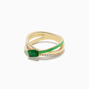 The Brasilica 14K Yellow Gold Emerald and Diamond Crossover Ring features a rectangular emerald center, crisscrossing diamond-accented bands, and a green enamel stripe.