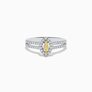 The Canare 18K Two-Tone Gold Marquise Shaped Yellow Diamond Ring showcases a vivid marquise-cut yellow diamond center, accented by a white diamond halo and additional diamonds along its elegant split shank band.