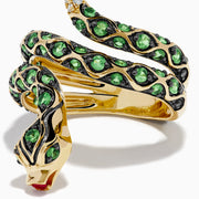 The 14K Yellow Gold Tsavorite and Diamond Snake Ring features a coiled snake design with tsavorites along its body, a red gemstone on its head, and diamonds accenting the tail.