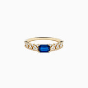 The 14K Yellow Gold Sapphire and Diamond Ring features a square-cut sapphire center with baguette and round-cut diamonds on the band, shown against a white background.