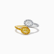 The Duo 14K 2-Tone Gold Yellow and White Diamond Toi Et Moi Ring features a white diamond surrounded by smaller diamonds on silver, and a yellow diamond accented by yellow stones on a 14K gold band, shown against a white background.