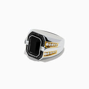 The Mens 14K White & Yellow Gold White and Black Diamond Onyx Ring features a large rectangular black onyx centerpiece, surrounded by white and black diamonds, with sparkling gems accenting the band.