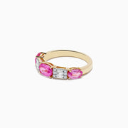 The 14k Yellow Gold Pink Sapphire and Diamond Ring features three round pink sapphires with two vertical rows of small white diamonds between each gemstone, all set against a plain white background.