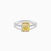 The Canare 18K Two Tone Gold Yellow and White Diamond Ring features a cushion-cut yellow diamond center held by gold prongs, accented with sparkling white diamonds along the band.