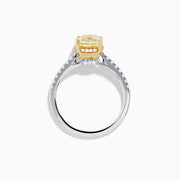 The Canare 18K Two Tone Gold Yellow and White Diamond Ring features a cushion-cut yellow diamond center held by gold prongs, accented with sparkling white diamonds along the band.
