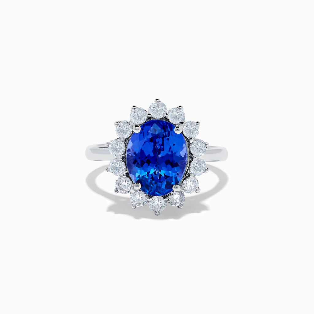 The Nahla Siri 14K White Gold Tanzanite and Diamond Ring showcases a large oval tanzanite center stone encircled by a halo of sparkling round white diamonds, all set in radiant 14K white gold.