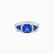 The Nahla Siri 14K White Gold Tanzanite and Diamond Ring showcases a large cushion-cut tanzanite center stone, flanked by two smaller tanzanites and accented with round diamonds along the band.