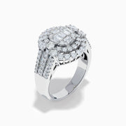 The 14K White Gold Diamond Cluster Ring showcases rectangular and round-cut diamonds in an oval setting with two halo layers on a diamond-accented split shank band.