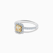 The Canare 18K Two Tone Gold White and Yellow Diamond Ring showcases a cushion-cut yellow diamond center, haloed by white diamonds, with a diamond-adorned band.