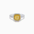 The Canare 18K Two Tone White and Yellow Diamond Ring showcases a square yellow center stone, encircled by yellow and white diamond halos, set on a band adorned with sparkling clear diamonds.
