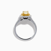 The Canare 18K Two Tone White and Yellow Diamond Ring showcases a square yellow center stone, encircled by yellow and white diamond halos, set on a band adorned with sparkling clear diamonds.