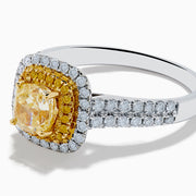 The Canare 18K Two Tone White and Yellow Diamond Ring showcases a square yellow center stone, encircled by yellow and white diamond halos, set on a band adorned with sparkling clear diamonds.