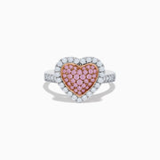 The Novelty 14K Two Tone Gold Pink and White Diamond Heart Ring features a heart-shaped centerpiece set with pink and white diamonds, accented by a sparkling border of clear, white stones.