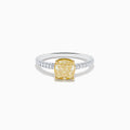 The Canare 18K Two Tone White and Yellow Diamond Ring features a cushion-cut yellow diamond centerpiece accented by small round white diamonds along the band.