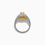 The 18K Two-Tone Gold Yellow Diamond Oval Halo Ring 1.63 TCW features a dazzling oval yellow diamond center with a halo and split shank band adorned with sparkling diamonds—a timeless, elegant design.