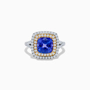 The Nahla Siri 14K Two Tone Gold Tanzanite and Diamond Ring features a large cushion-cut tanzanite center, encircled by a halo of yellow stones and an outer halo of sparkling diamonds.
