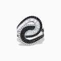 The 14K White Gold Black and White Diamond Swirl Ring features an abstract interlocking design with alternating rows of black and white diamonds in a bold, modern setting.