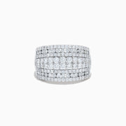 The 14K White Gold Diamond Wide Band Statement Ring showcases multiple rows of closely set round white diamonds, creating a dazzling and luxurious look against its wide, polished band. The background is plain white.