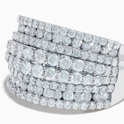 The 14K White Gold Diamond Wide Band Statement Ring showcases multiple rows of closely set round white diamonds, creating a dazzling and luxurious look against its wide, polished band. The background is plain white.
