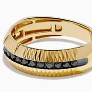 The Men's 14K Yellow Gold Black Diamond Geometric Ring features a textured, ridged band with a row of small black diamonds set around the center.